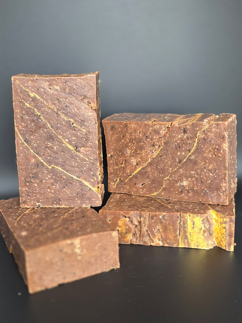 Gilded Espresso is a handcrafted cold process soap made in small batches with rich espresso and dark chocolate notes, natural coffee elements, and a gold-veined design.