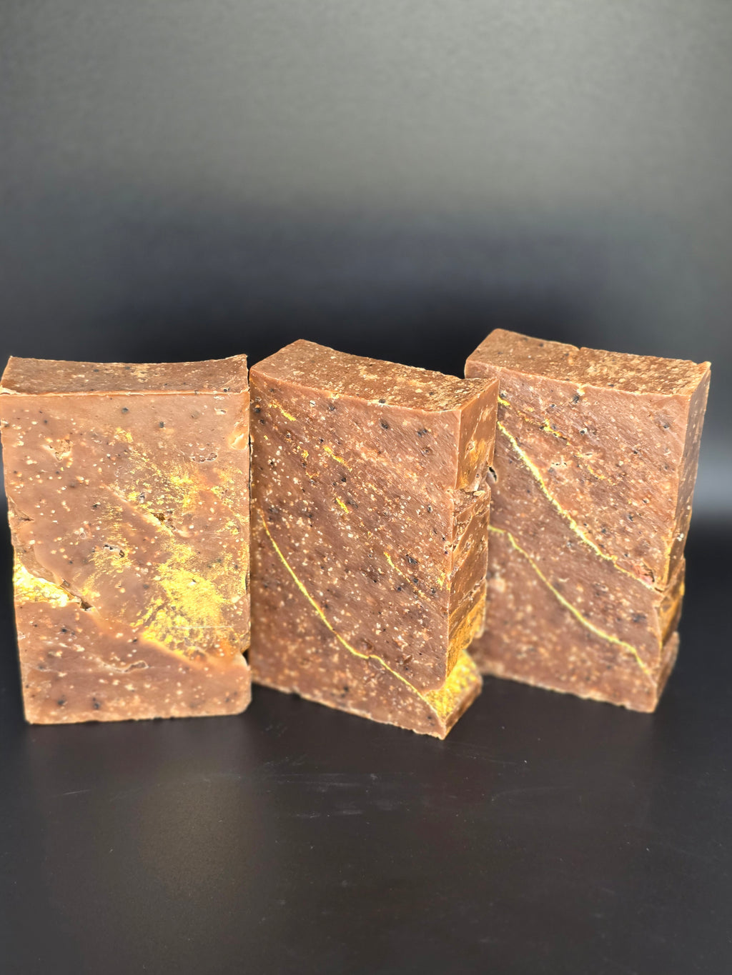 Gilded Espresso is a handcrafted cold process soap made in small batches with rich espresso and dark chocolate notes, natural coffee elements, and a gold-veined design.