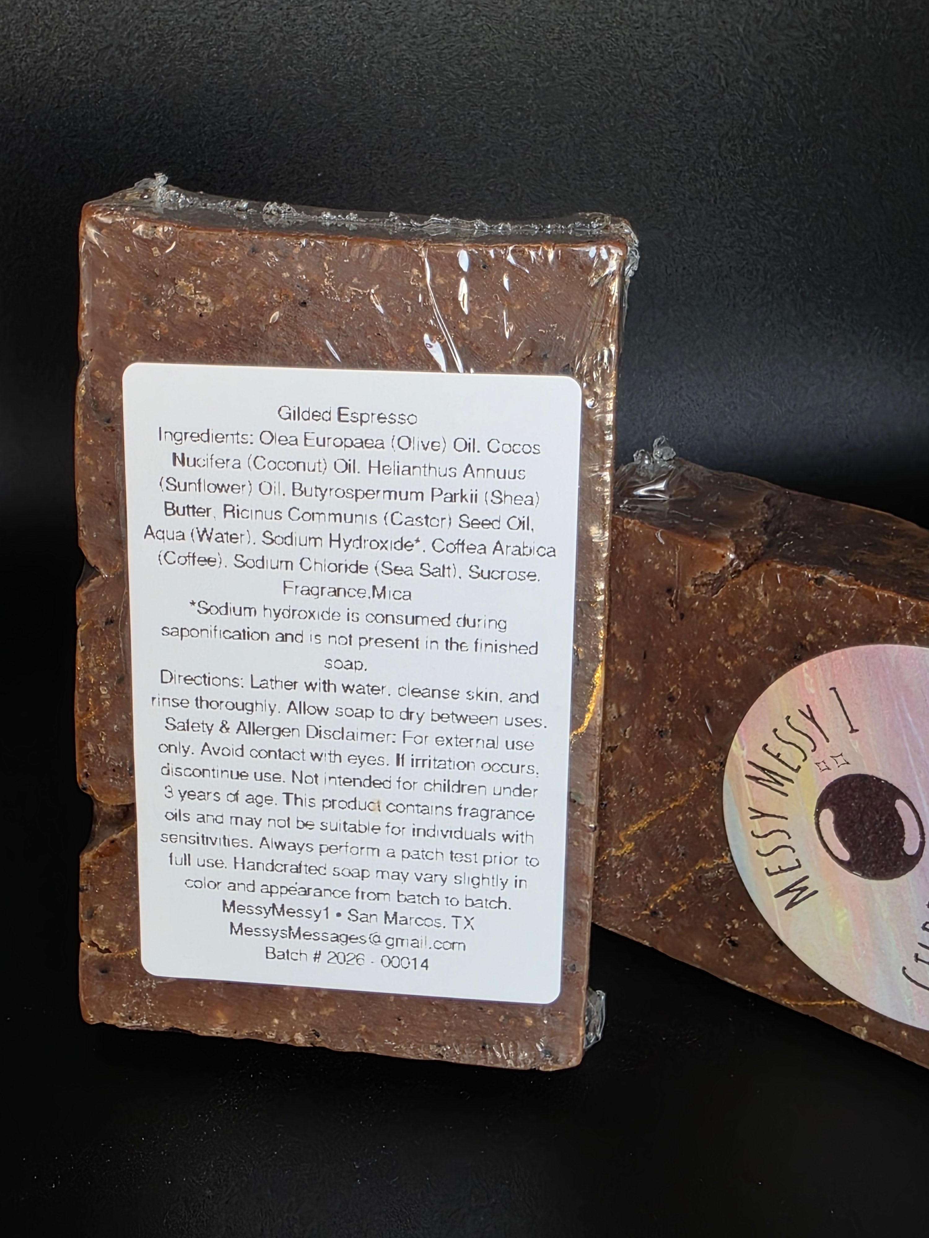 Gilded Espresso is a handcrafted cold process soap made in small batches with rich espresso and dark chocolate notes, natural coffee elements, and a gold-veined design.
