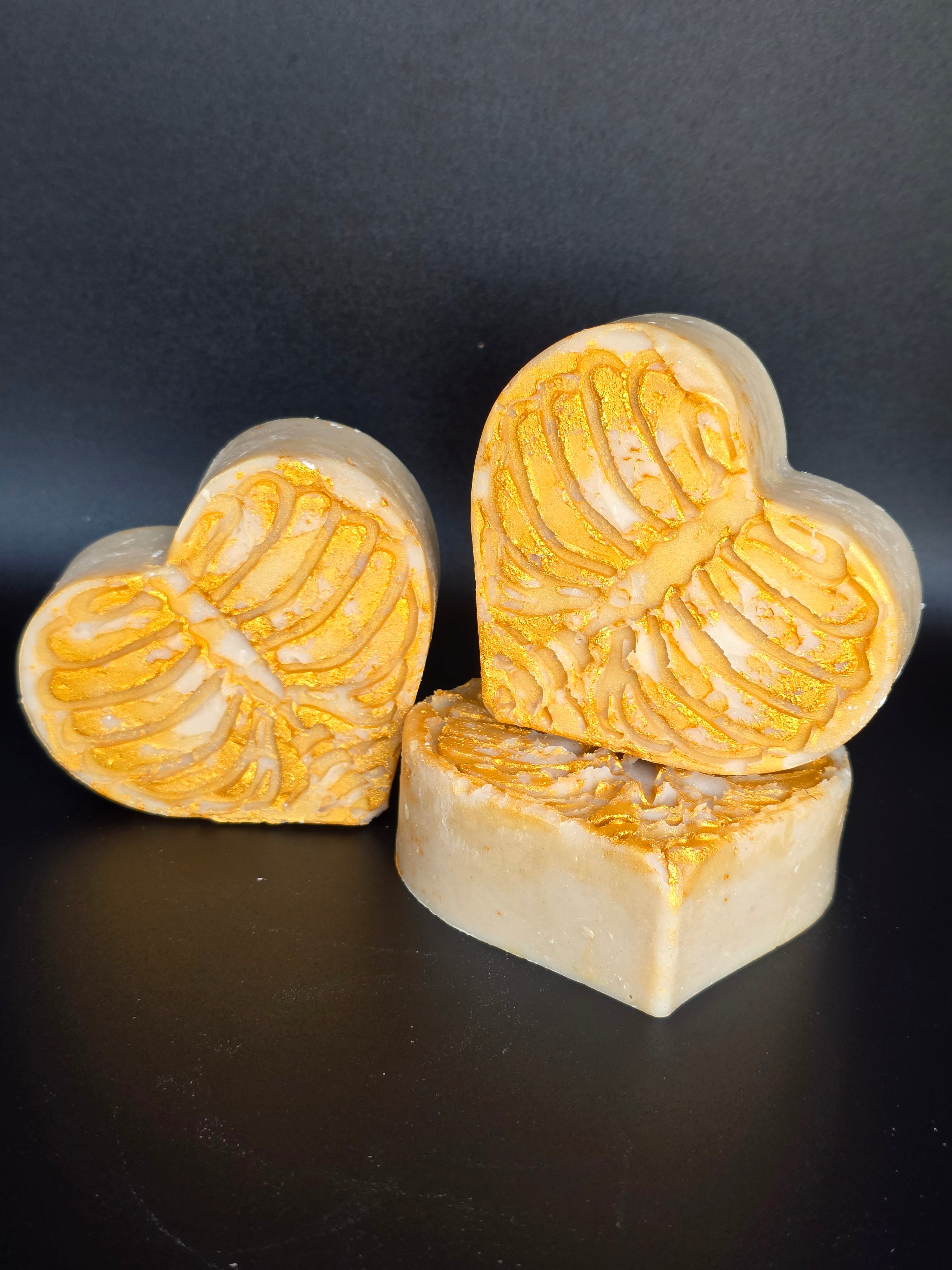 Golden Remains is a handcrafted cold process soap made in small batches from leftover Spring Solstice batter, poured into a detailed heart mold with a skeletal design and finished with gold mica. Lmited soap